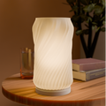 Spiral table lamp with spiraling shade on modern base
