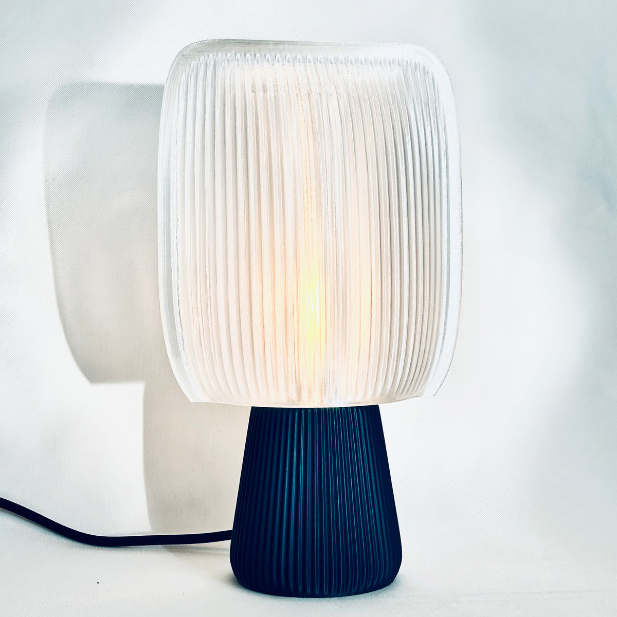 Bliss table lamp with soft pillow-shaped shade on a round base, view 3