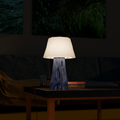 Vertex table lamp with openwork base and curved shade